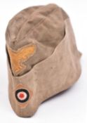 A Third Reich Tropical type Luftwaffe mans field cap, faded light khaki colour with badges. GC £30-