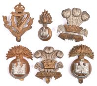 Six Irish cap badges: pre 1926 Inniskilling Fusiliers, post 1934 Inniskilling Fusiliers, small
