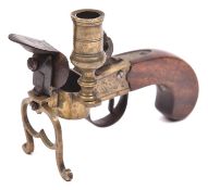 An early 19th century brass framed flintlock tinder lighter/candle holder, 5½" overall, engraved