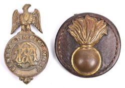 An ear boss, brass grenade on leather backing, attached label states "Turkey 1914"; and a Boer bit