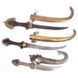 2 Arab jambiyas, wooden hilts with sheaths and hilt mountings of brass and WM overlay; and another