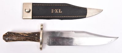 A large Bowie knife, clipped back blade 9½" with partly scalloped back edge, bearing eagle mark