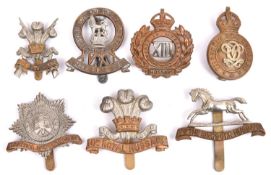 Seven Cavalry cap badges: 4th Dgn Guards, 3rd Carabiniers, post 1920 3rd Hussars, 7th Hussars,