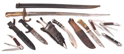 A Chassepot bayonet, in its scabbard; 2 sheath knives, a small kukri, 3 clasp knives and a folding