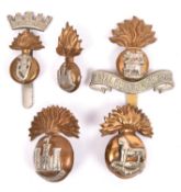 Five Irish cap badges: pre 1926 Inniskilling Fusiliers with lugs, small Inniskilling for side cap;