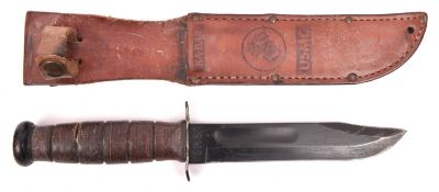 A USMC Mark I Ka Bar knife, the blackened blade marked "USMC" and "KA-BAR OLEAN-N.Y.", in its