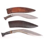 A kukri, with embossed iron hilt, in its military style leather covered sheath; and another kukri,