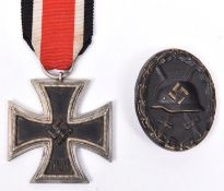 A Third Reich Iron Cross 2nd class, with ribbon; also a wound badge (blackened) above average GC. (