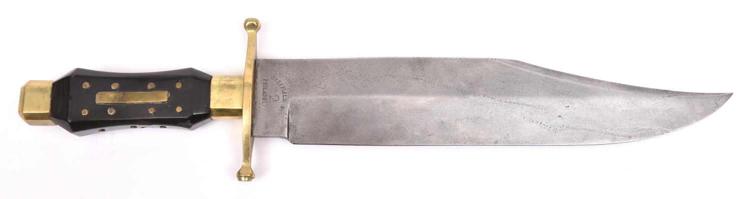 A Bowie knife, broad clipped back blade 10½" stamped "Sheffield Works/ 2/ Philadelphia", the hilt