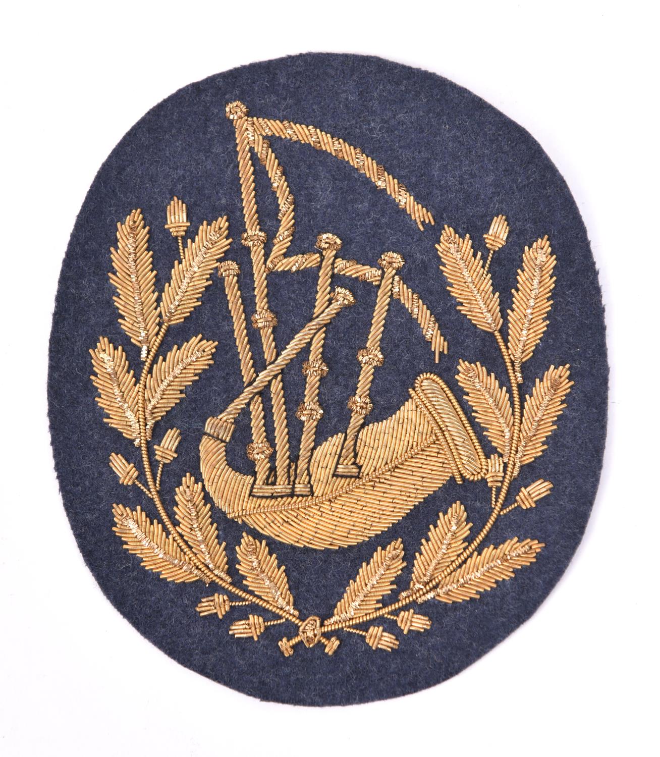 A scarce RAF pipers arm badge, gilt bullion on RAF grey cloth. VGC £100-120