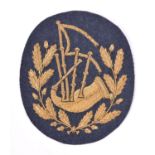 A scarce RAF pipers arm badge, gilt bullion on RAF grey cloth. VGC £100-120