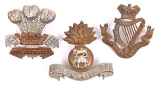 Three Irish cap badges: Vic Connaught Rangers, Leinster with two lugs, and Ryl Dublin Fusiliers with