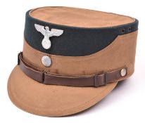 A Third Reich SA man's brown kepi, green cloth crown with alloy eagle and buttons, brown leather