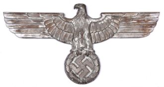 A large Third Reich silvered cast iron wall eagle, span 26½", with 4 threaded mounting bosses to the