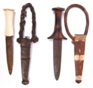 A Sudanese arm dagger, plain flat blade 5¼", with plain partly turned wood hilt with flat disc