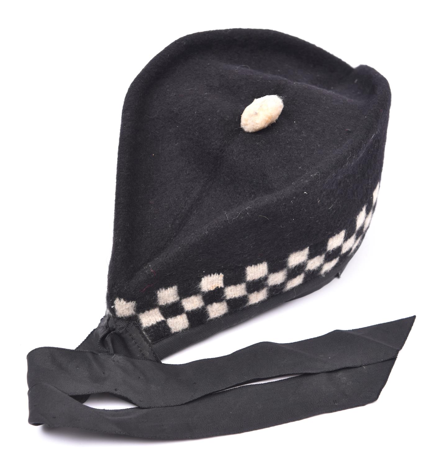 A Scottish glengarry cap, with black and white diced band, two tails, and replica brass badge of the - Image 2 of 2