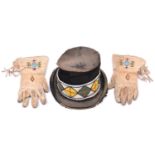 A pair of native American Indian gloves and a hat from Buffalo Bill's Wild West Show, c 1904, the
