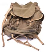 A WWII British Army Bergen rucksack, green canvas with brass and leather fittings, dated 1945, GC £