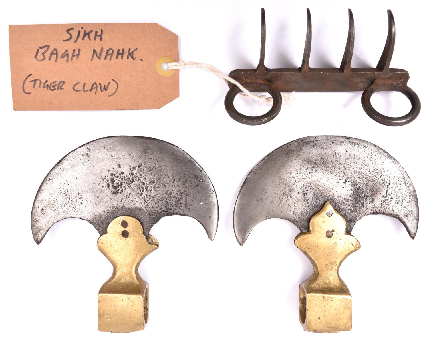 A reproduction Indian tiger claw weapon, Bagh Nakh; and a pair of Indian axe heads with crescent