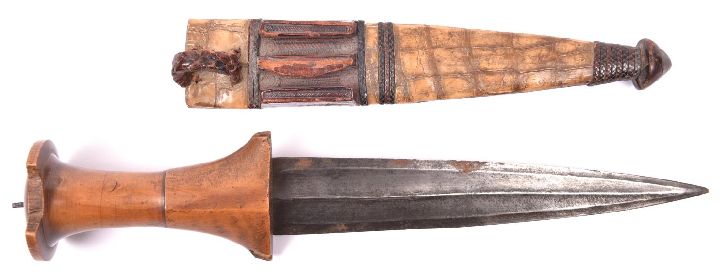 A Sudanese arm dagger, fluted blade 7" with central rib, plain wood hilt with turned upper part