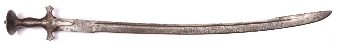 An Indian tulwar, heavy blade 29" with 7" back edge, crudely etched for almost its entire length