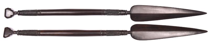 A pair of decorative African short ebony spears, 26" overall, with bands of spirally fluted
