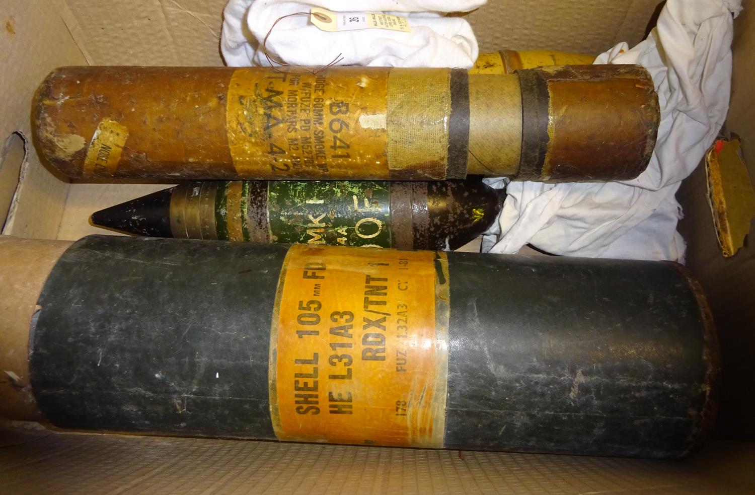 A 3" mortar bomb, flash bem, a shell head, a fibre container for a US 60mm mortar smoke cartridge;