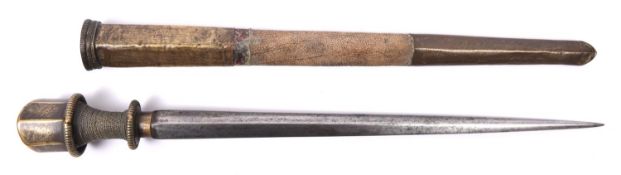 A Tibetan dagger, tapered blade 12" of stout diamond section, the hilt of brass with beaded edge