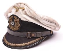 A Third Reich Naval officer's white top peaked cap, with bullion badge and brass eagle, and maker'