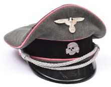 A Third Reich SS Panzer officer's peaked cap, with metal skull and eagle, silver bullion cords,
