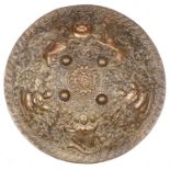 A decorative Indian brass shield dhal, 19" diameter, deeply embossed overall with pair of rampant