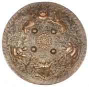 A decorative Indian brass shield dhal, 19" diameter, deeply embossed overall with pair of rampant