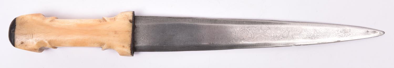 A Sudanese dagger, the imported tapered 9½" blade of watered steel, with one piece bone hilt and