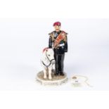 A china figure of a Parachute Regiment Corporal with a pony mascot, 7¾" height, marked on base "Corp