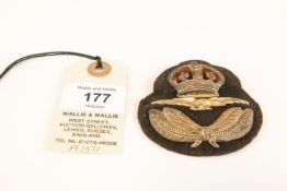 A scarce first pattern RAF officer's cap badge, 1918, of 3 piece construction on a steel back plate,