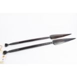 A pair of decorative African short ebony spears, 26" overall, with bands of spirally fluted