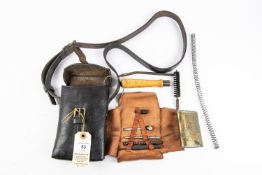 A Third Reich MP34 cleaning kit in black leather carrying case, contains an assortment of tools.