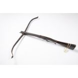 A mid 18th century crossbow, steel span 36", dark walnut stock 35" with wavy steel sideplates,