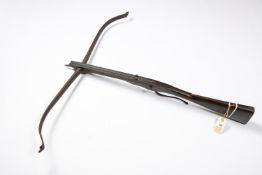 A mid 18th century crossbow, steel span 36", dark walnut stock 35" with wavy steel sideplates,