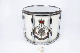 A side drum, with white body and chrome mounts, and large QEII transfer badge of the 1st Royal