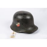 The skull only of a German M1916 steel helmet, reissued during the Third Reich, with applied tri-
