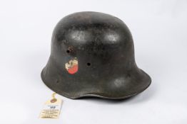 The skull only of a German M1916 steel helmet, reissued during the Third Reich, with applied tri-