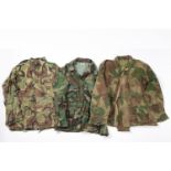 A 1950s Belgian Army Airborne smock; a US frog and leaf smock and a British 1968 pattern camo