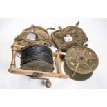 A reel of DIO assault cable, with wooden laying frame; also another empty reel and 2 canvas reel