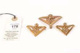 A scarce cap badge (with slider) and pair of collar badges of the RAF Works and Buildings