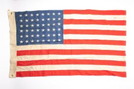 A US flag, bearing 48 stars, 60" x 35", marked on edge 1944 and "Boston Massachusetts". GC £65-75