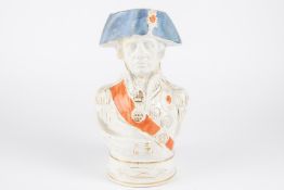 An old glazed earthenware ?character? jug in the form of Admiral Nelson, wearing medals and