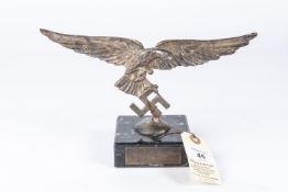 A Third Reich Luftwaffe desk ornament, in the form of a white metal Luftwaffe eagle mounted on a