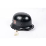 A Third Reich Fire Police double decal steel helmet, with smooth black finish, pale brown lining,