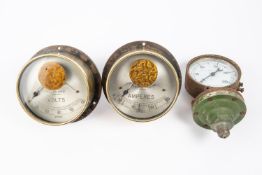 A pair of large early 20th century brass cased gauges from an electricity control panel, for Amperes